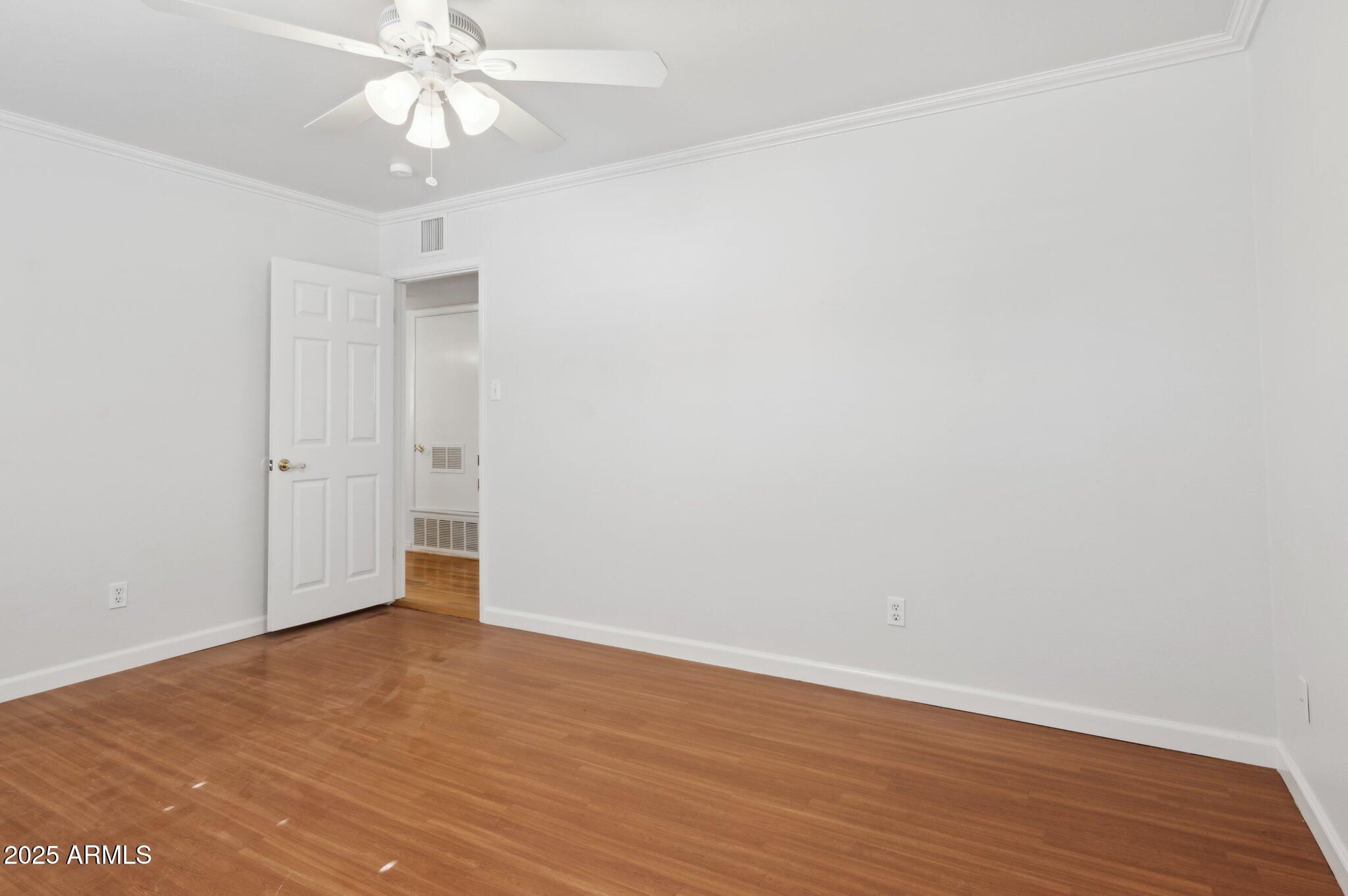 602 West Palmaire Avenue Phoenix, AZ 85021 - Photo 16 of 33 an empty room with wooden floor and fan