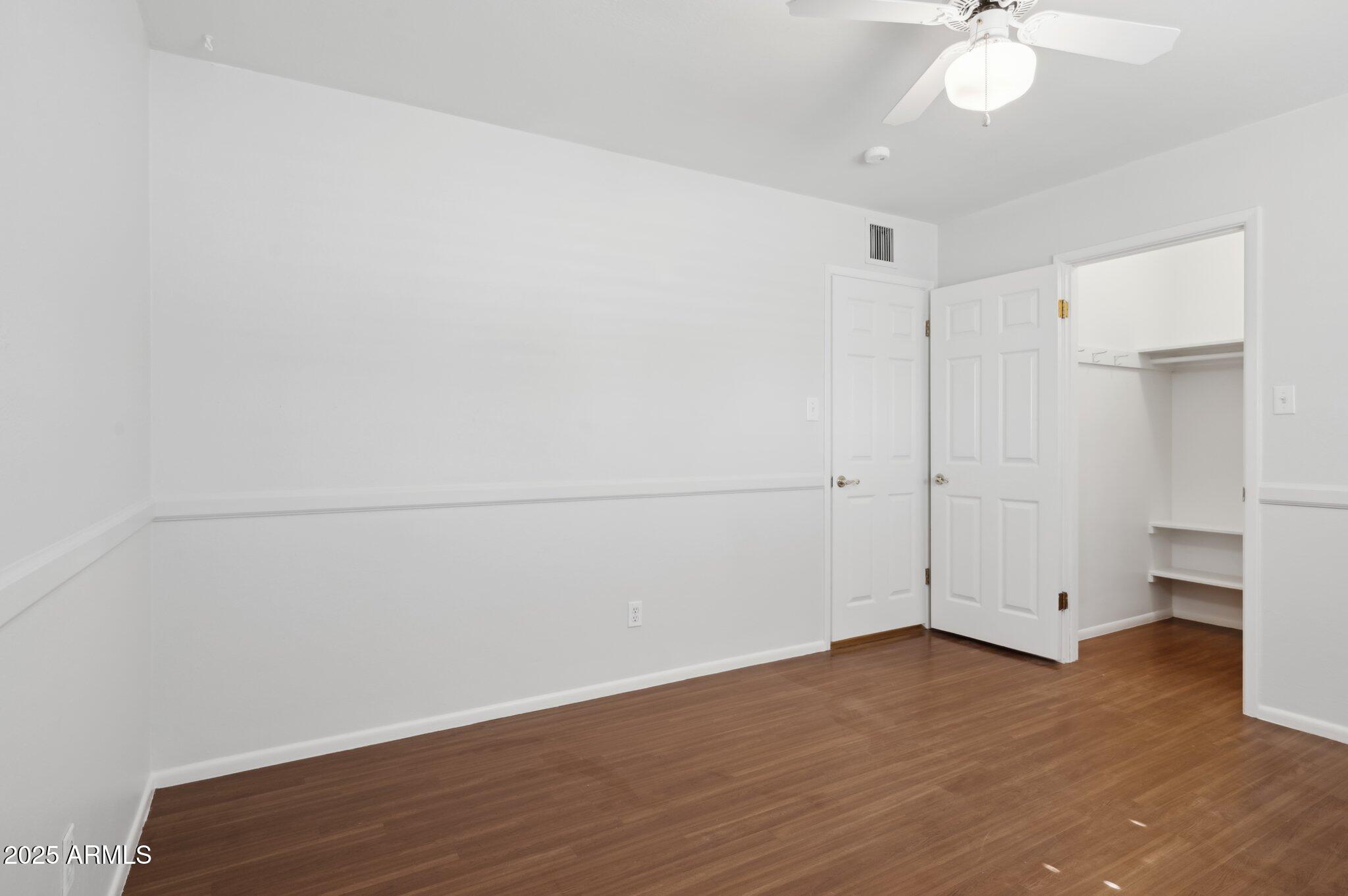 602 West Palmaire Avenue Phoenix, AZ 85021 - Photo 18 of 33 a view of an empty room with wooden floor
