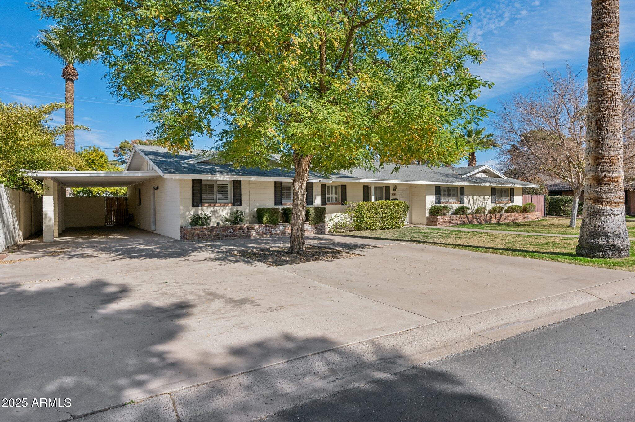 602 West Palmaire Avenue Phoenix, AZ 85021 - Photo 2 of 33 a view of a white house with a large space and a yard