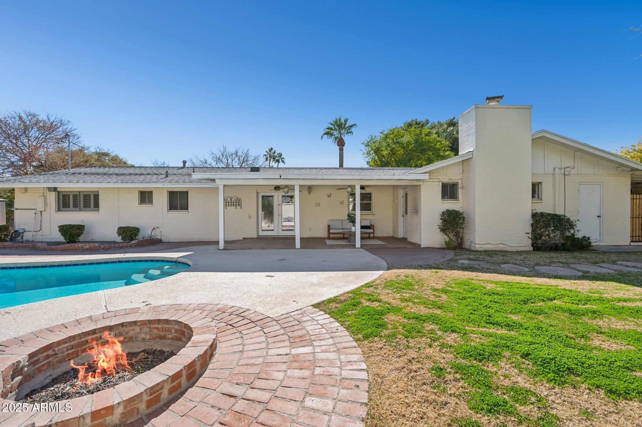 602 West Palmaire Avenue Phoenix, AZ 85021 - Photo 30 of 33 a view of a white house with a swimming pool and a yard