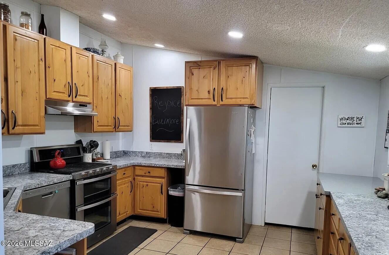 11323 North Anway Road Marana, AZ 85653 - Photo 3 of 3 a kitchen with stainless steel appliances granite countertop a refrigerator stove and sink