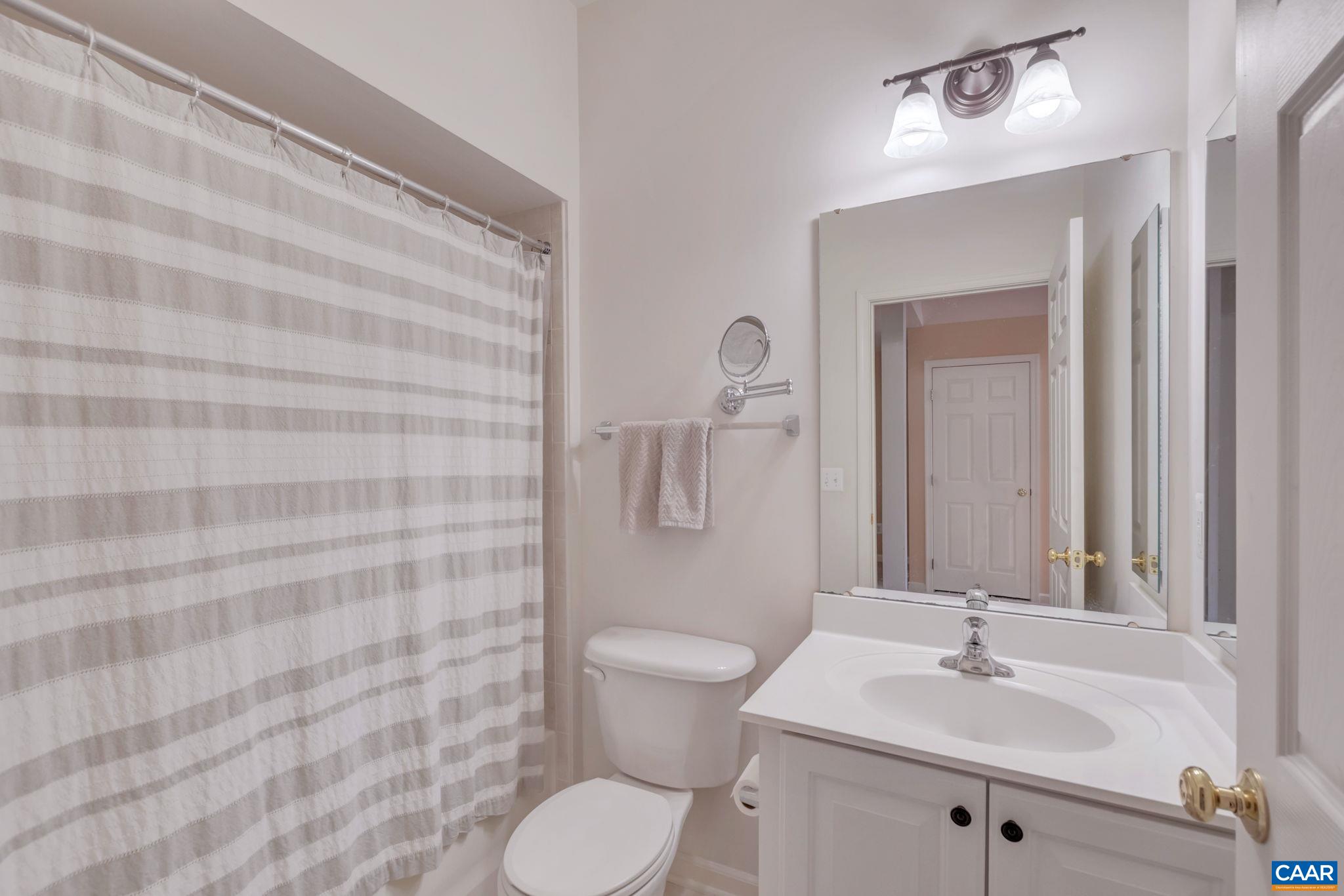 902 Rainier Road Charlottesville, VA 22903 - Photo 7 of 42 a bathroom with a sink a toilet and shower curtain