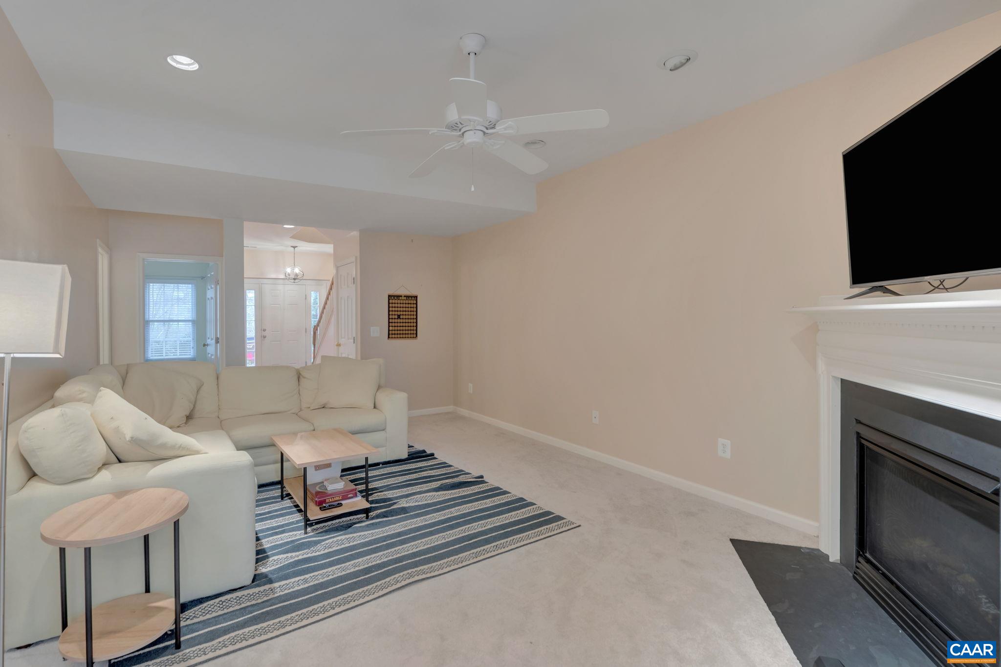 902 Rainier Road Charlottesville, VA 22903 - Photo 10 of 42 a living room with furniture and a flat screen tv