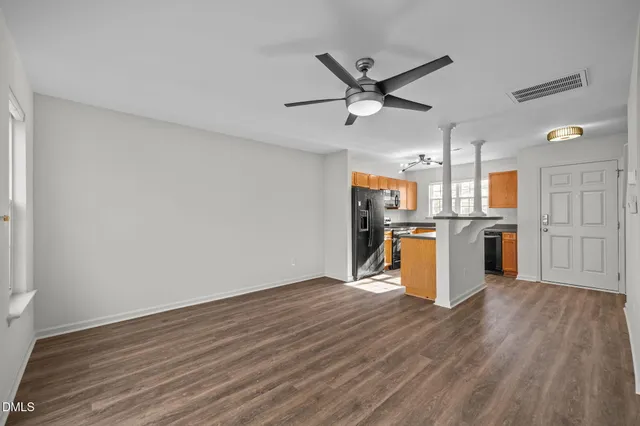 a balcony with wooden floor and trees