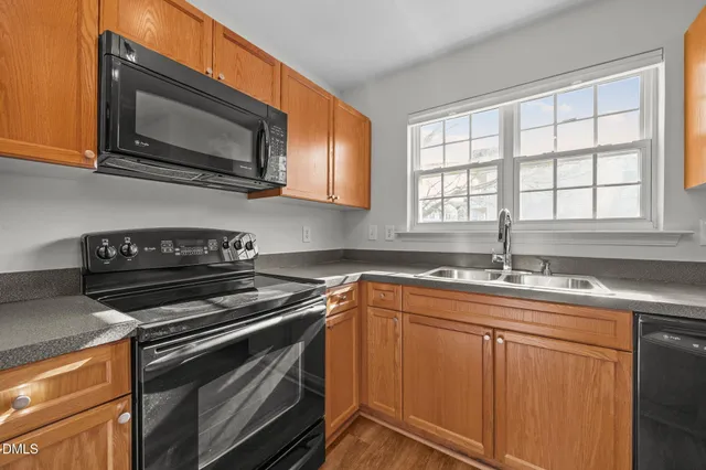 a view of kitchen with furniture and refrigerator