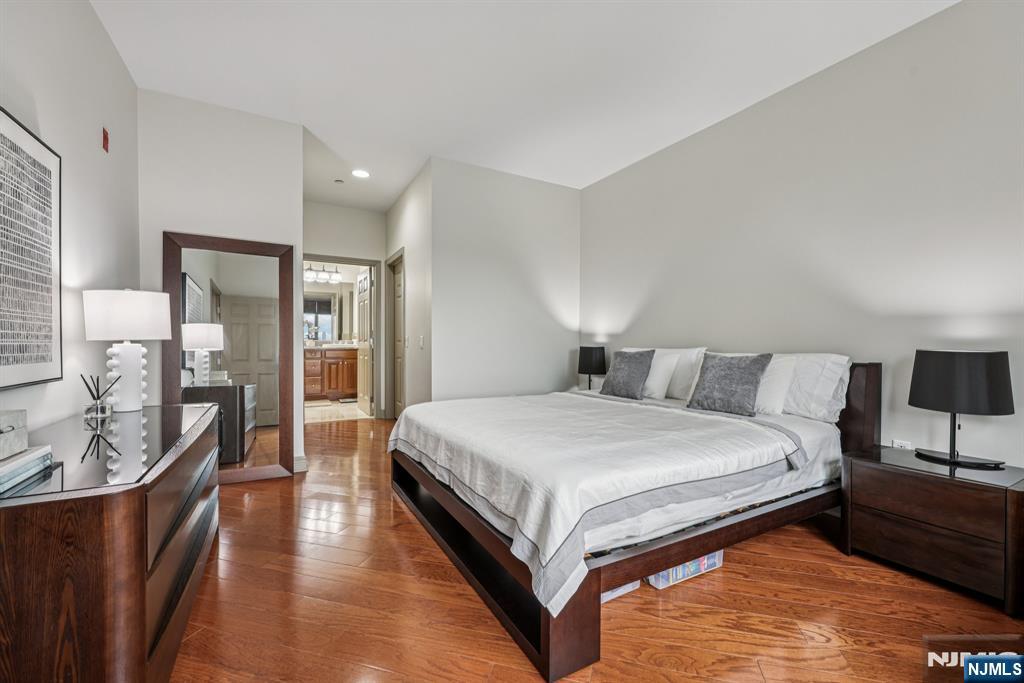 7400 River Road, Unit 409 North Bergen, NJ 07047 - Photo 11 of 30 a spacious bedroom with a bed and wooden floor