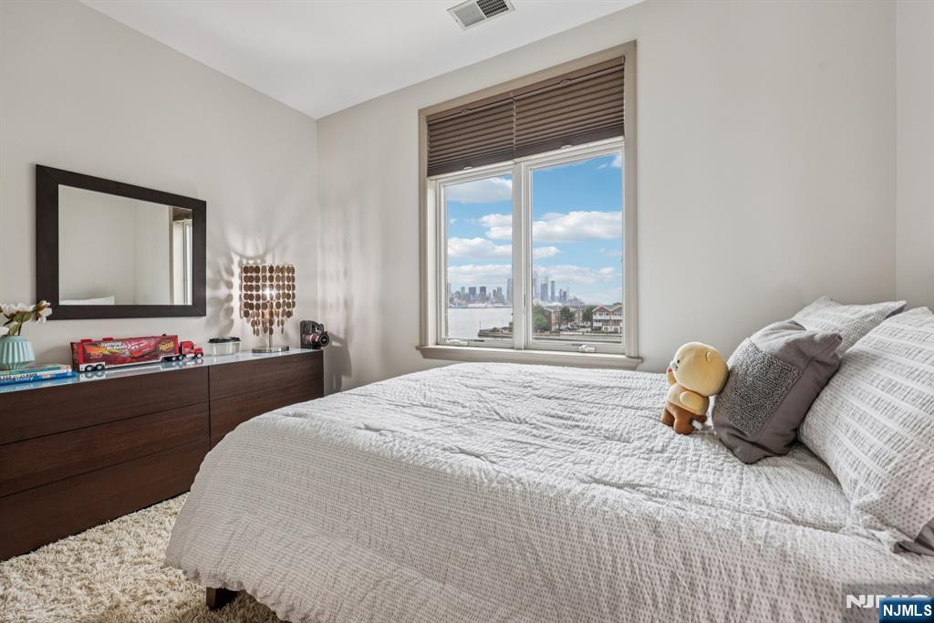 7400 River Road, Unit 409 North Bergen, NJ 07047 - Photo 13 of 30 a bedroom with a bed and a large window