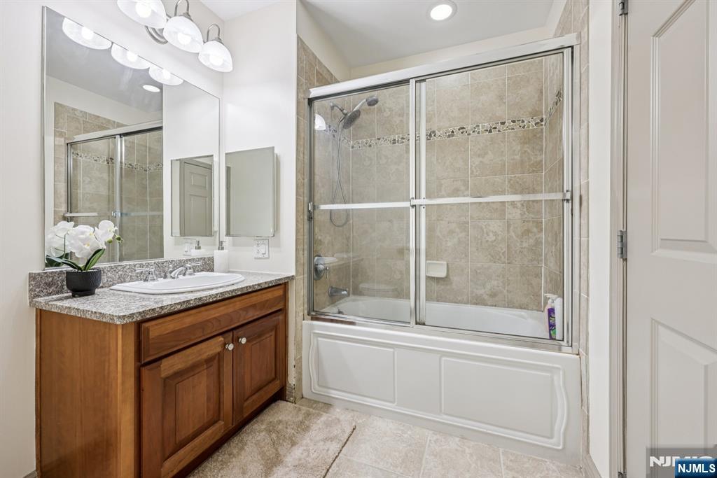 7400 River Road, Unit 409 North Bergen, NJ 07047 - Photo 15 of 30 a bathroom with a granite countertop sink a toilet and shower