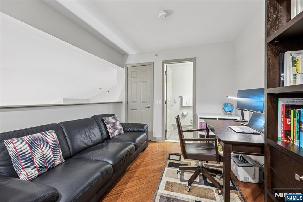 7400 River Road, Unit 409 North Bergen, NJ 07047 - Photo 16 of 30 a living room with furniture a bookshelf and a window