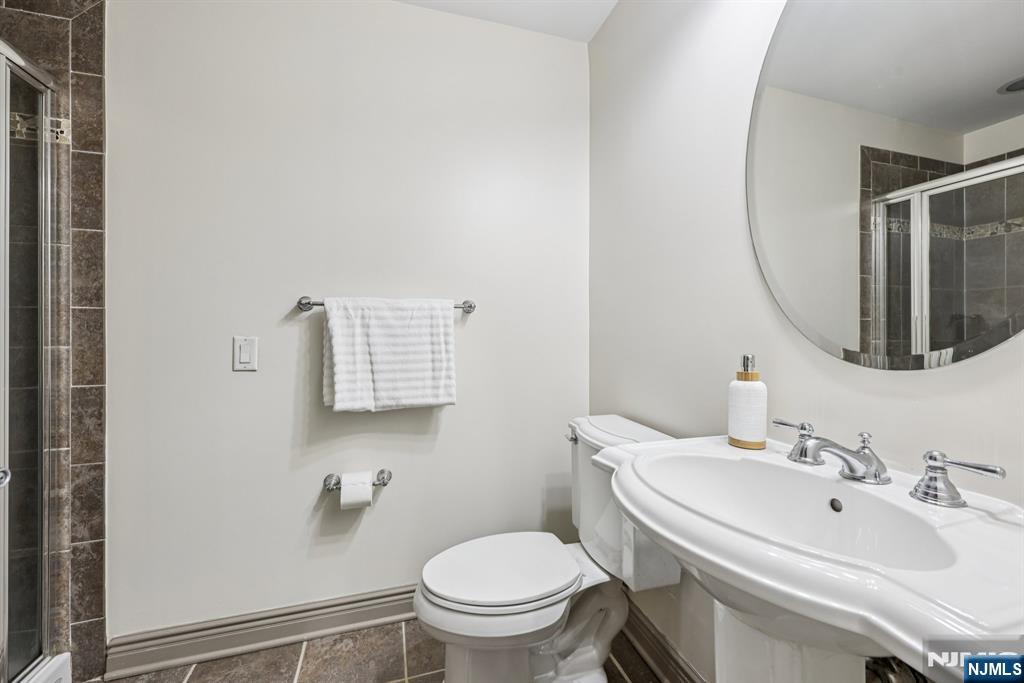 7400 River Road, Unit 409 North Bergen, NJ 07047 - Photo 18 of 30 a bathroom with a sink toilet and a mirror