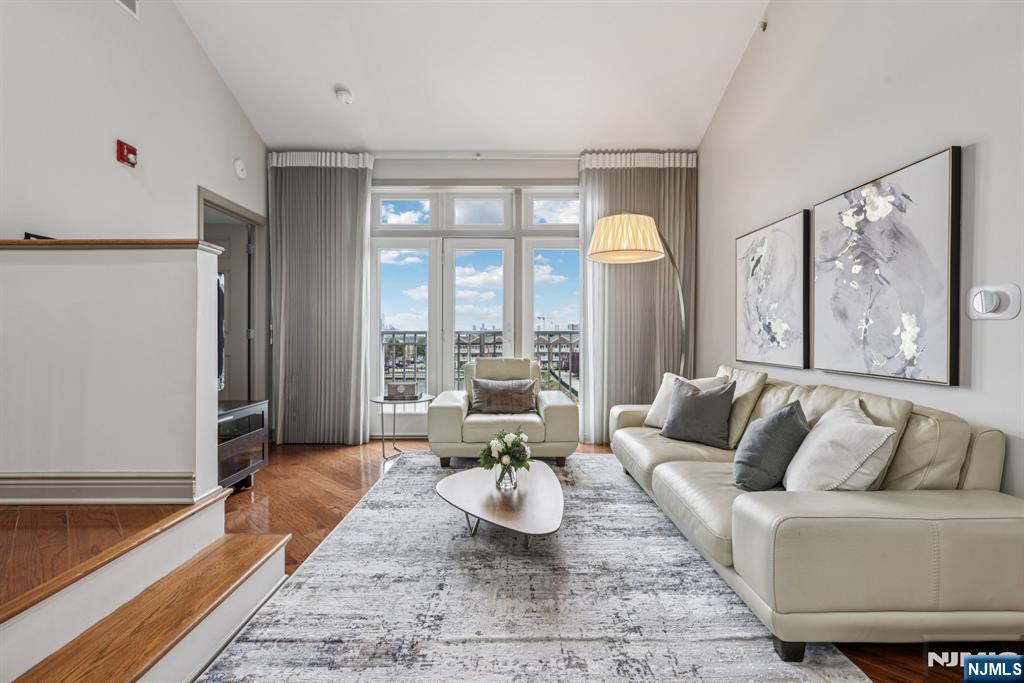 7400 River Road, Unit 409 North Bergen, NJ 07047 - Photo 2 of 30 a living room with furniture and a large window