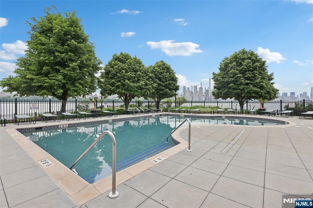 7400 River Road, Unit 409 North Bergen, NJ 07047 - Photo 25 of 30 a view of swimming pool with outdoor seating and plants