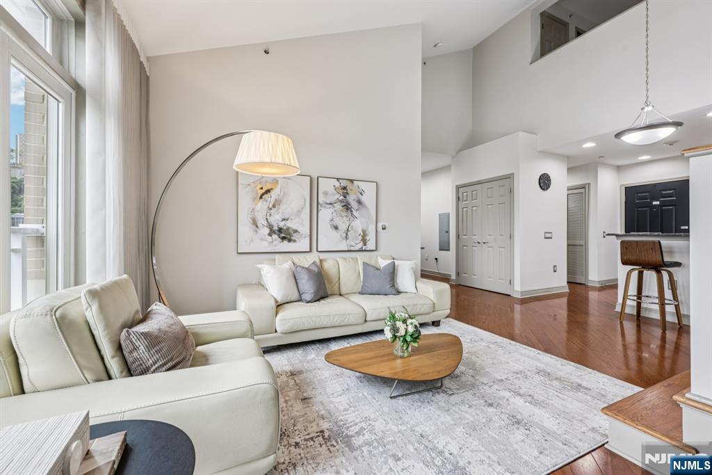 7400 River Road, Unit 409 North Bergen, NJ 07047 - Photo 3 of 30 a living room with furniture and a wooden floor