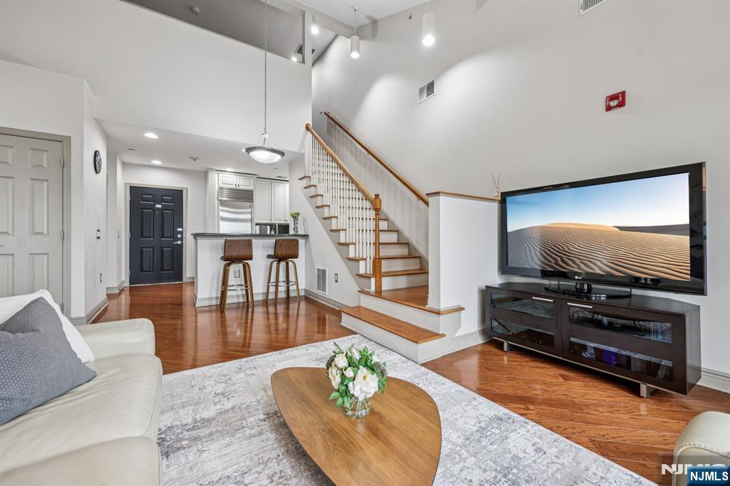 7400 River Road, Unit 409 North Bergen, NJ 07047 - Photo 4 of 30 a living room with furniture and a flat screen tv