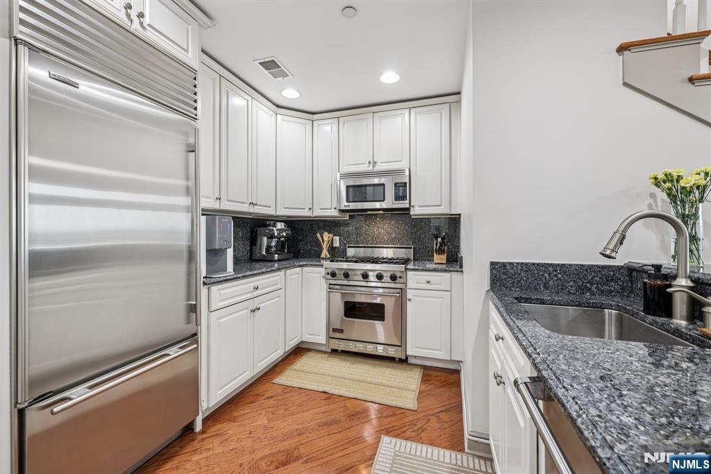 7400 River Road, Unit 409 North Bergen, NJ 07047 - Photo 6 of 30 a kitchen with granite countertop stainless steel appliances and sink