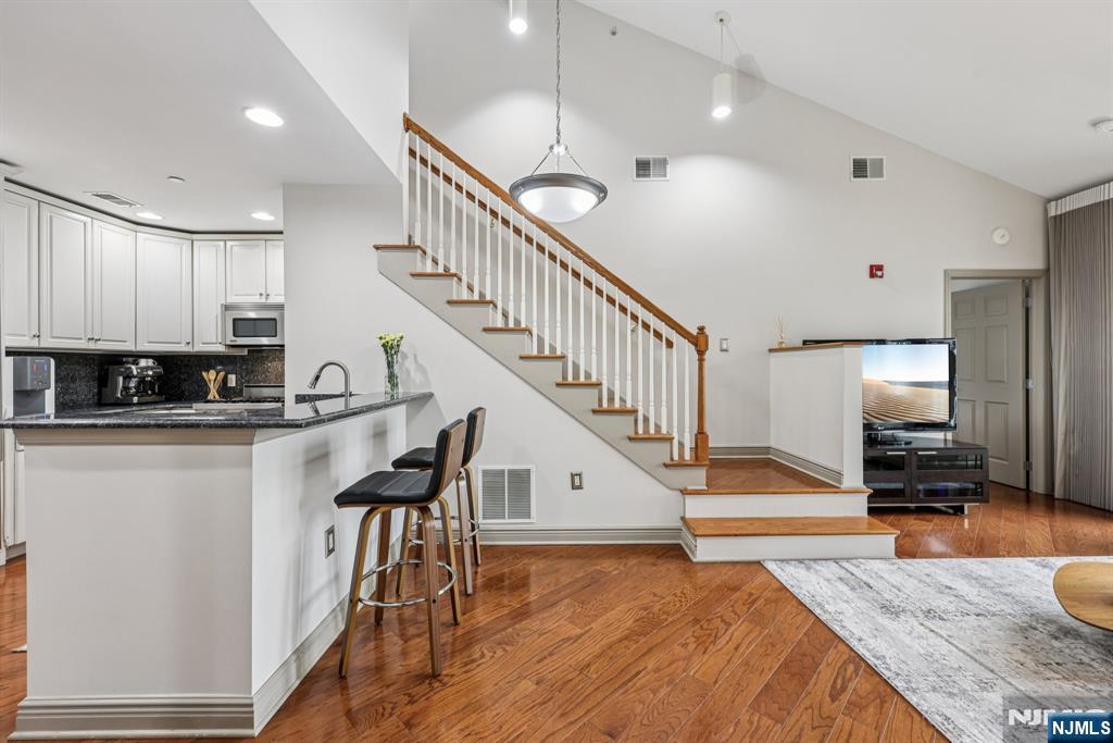 7400 River Road, Unit 409 North Bergen, NJ 07047 - Photo 8 of 30 a view of a kitchen with cabinets and wooden floor
