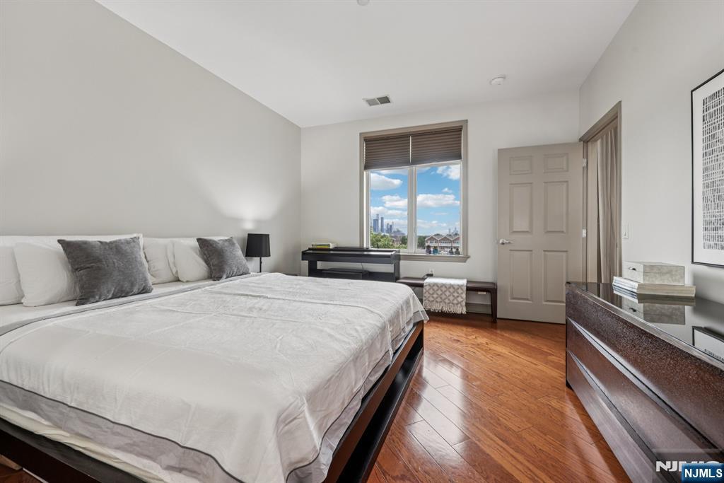 7400 River Road, Unit 409 North Bergen, NJ 07047 - Photo 10 of 30 a spacious bedroom with a bed and a large window