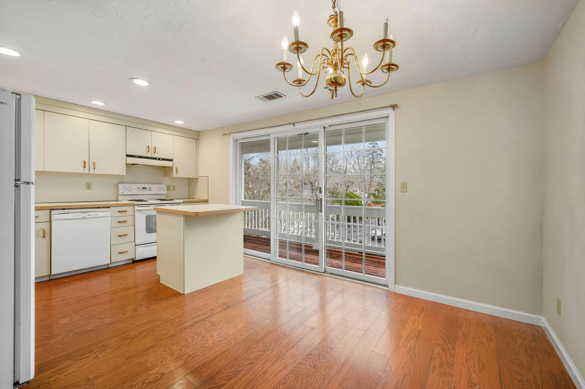 727 Main Street, Unit C3 Osterville, MA 02655 - Photo 11 of 23 a kitchen with a wooden floor and window