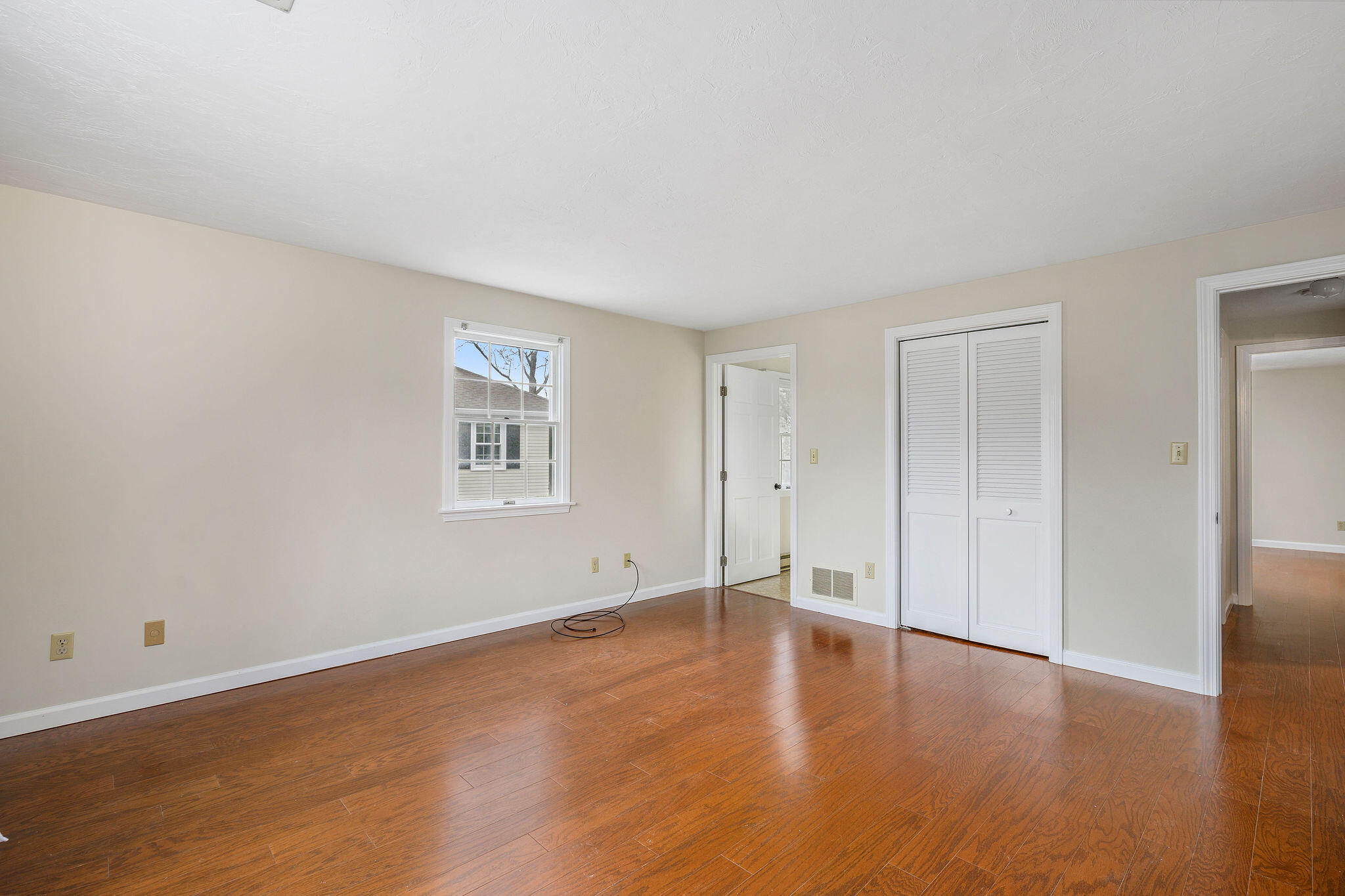 727 Main Street, Unit C3 Osterville, MA 02655 - Photo 15 of 23 a view of an empty room with wooden floor and a window