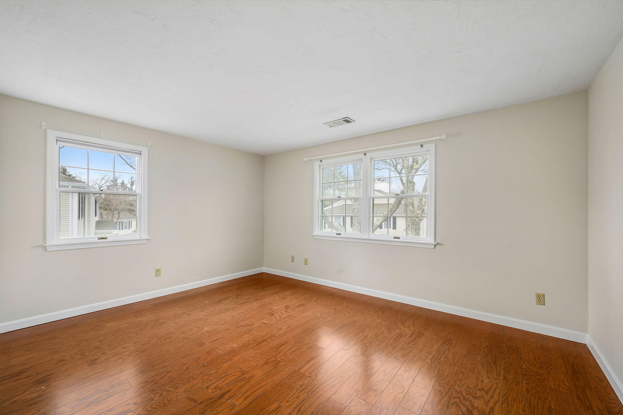 727 Main Street, Unit C3 Osterville, MA 02655 - Photo 16 of 23 a view of an empty room with a window and wooden floor