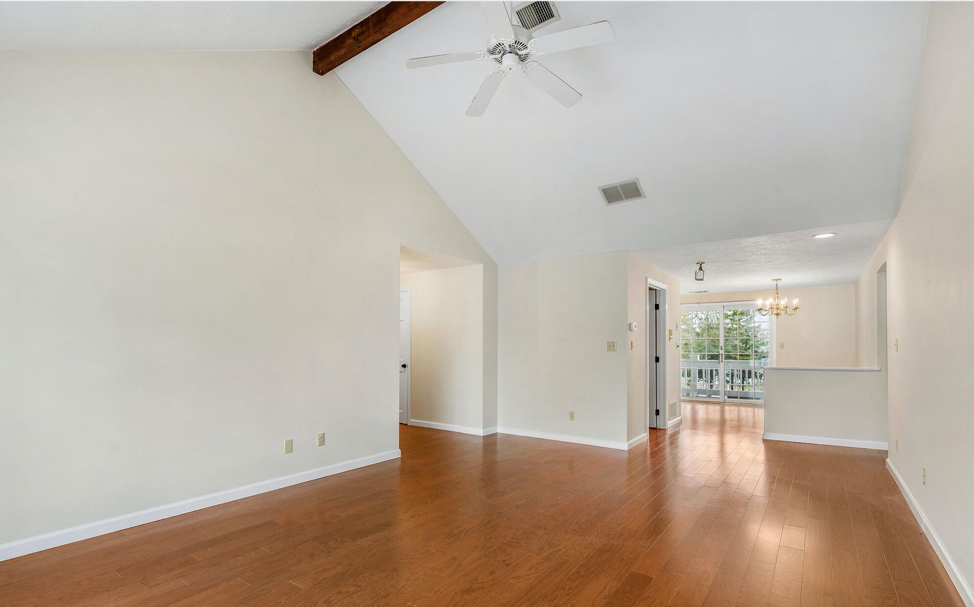 727 Main Street, Unit C3 Osterville, MA 02655 - Photo 3 of 23 a view of an empty room with wooden floor and a window
