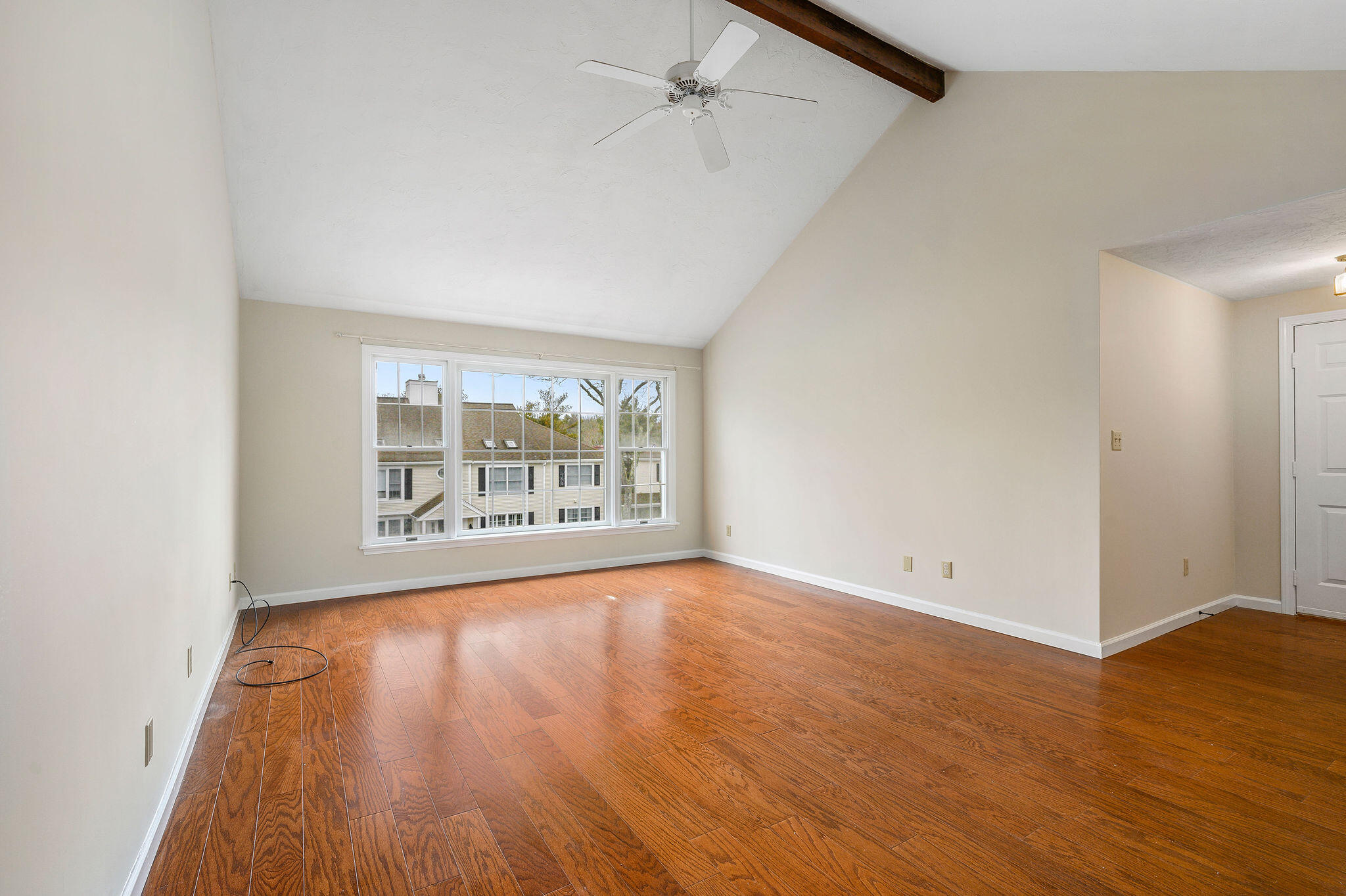 727 Main Street, Unit C3 Osterville, MA 02655 - Photo 4 of 23 an empty room with wooden floor and windows
