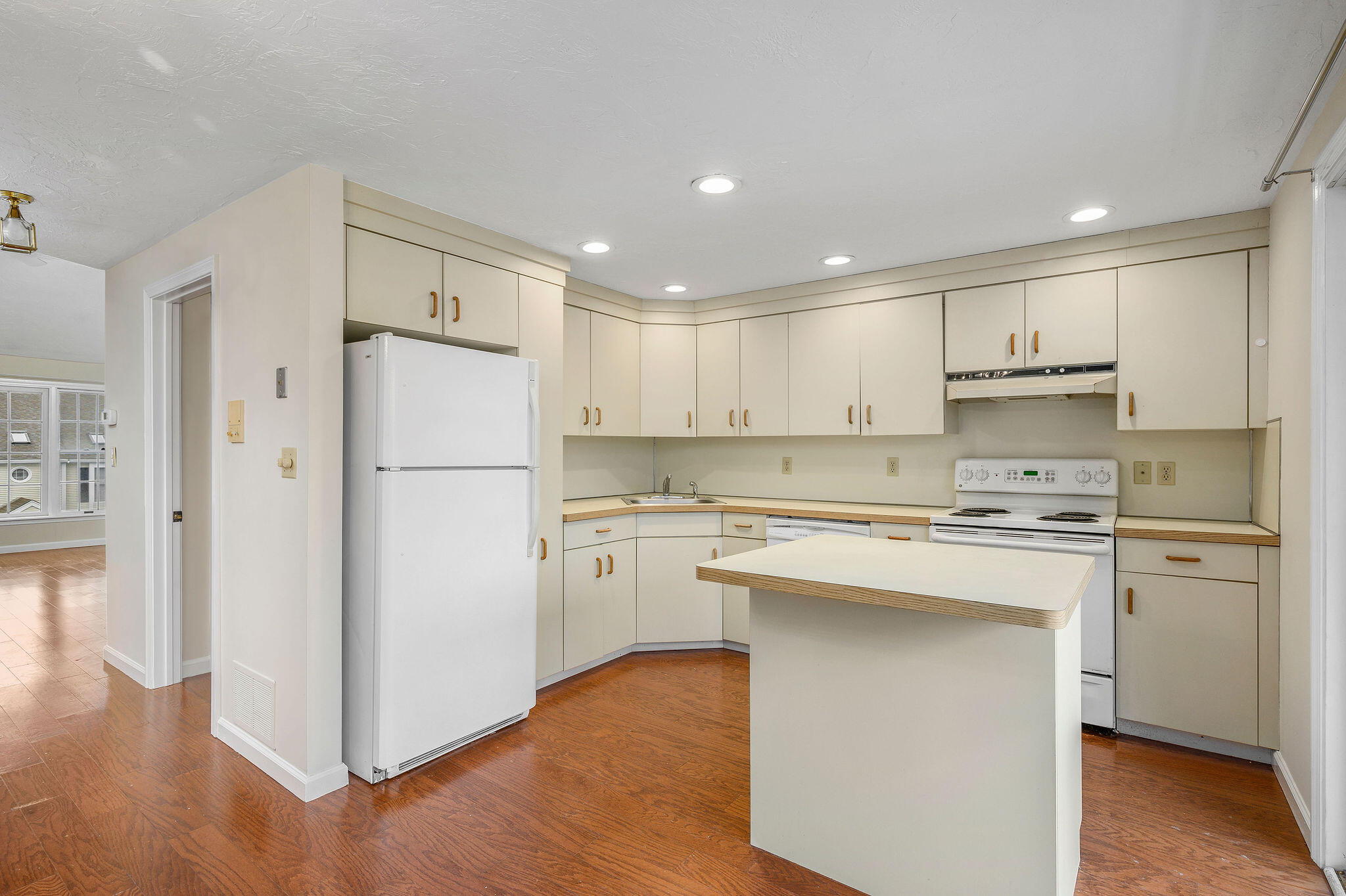 727 Main Street, Unit C3 Osterville, MA 02655 - Photo 9 of 23 a kitchen with a refrigerator a stove top oven and a center island