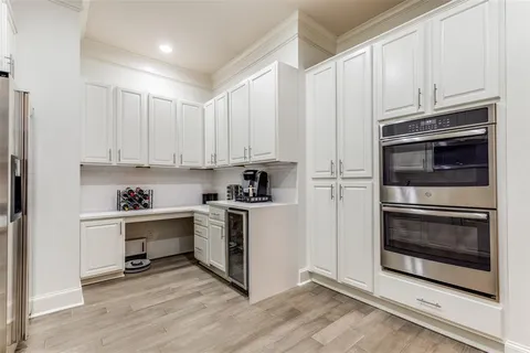 a kitchen with granite countertop white cabinets stainless steel appliances and sink