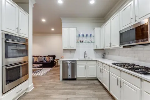 a kitchen with stainless steel appliances a stove microwave and cabinets