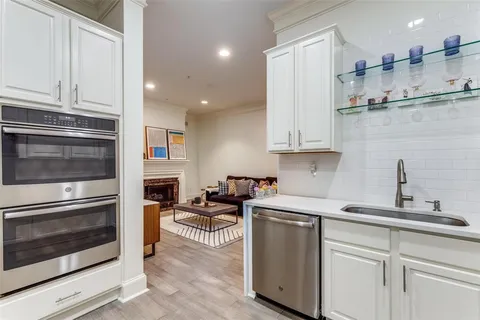 a kitchen with stainless steel appliances granite countertop a stove and white cabinets
