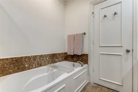 a bathroom with a bathtub and shower