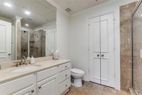 a bathroom with a double vanity sink toilet and shower