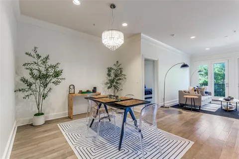a living room with furniture a window and a potted plant