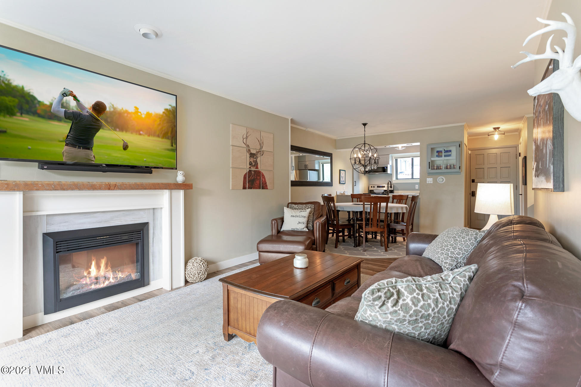 980 Vail View Drive, Unit 211B Vail, CO 81657 - Photo 12 of 21 a living room with furniture and a fireplace