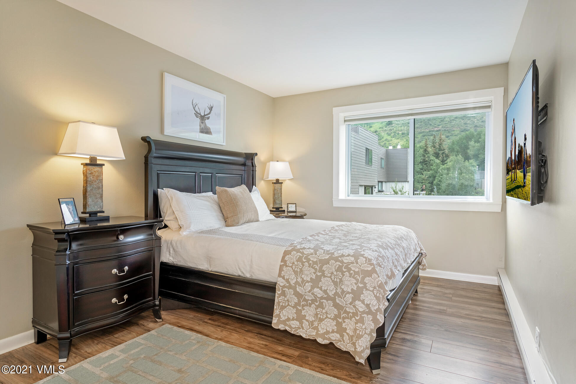 980 Vail View Drive, Unit 211B Vail, CO 81657 - Photo 13 of 21 a bedroom with a bed and a large window