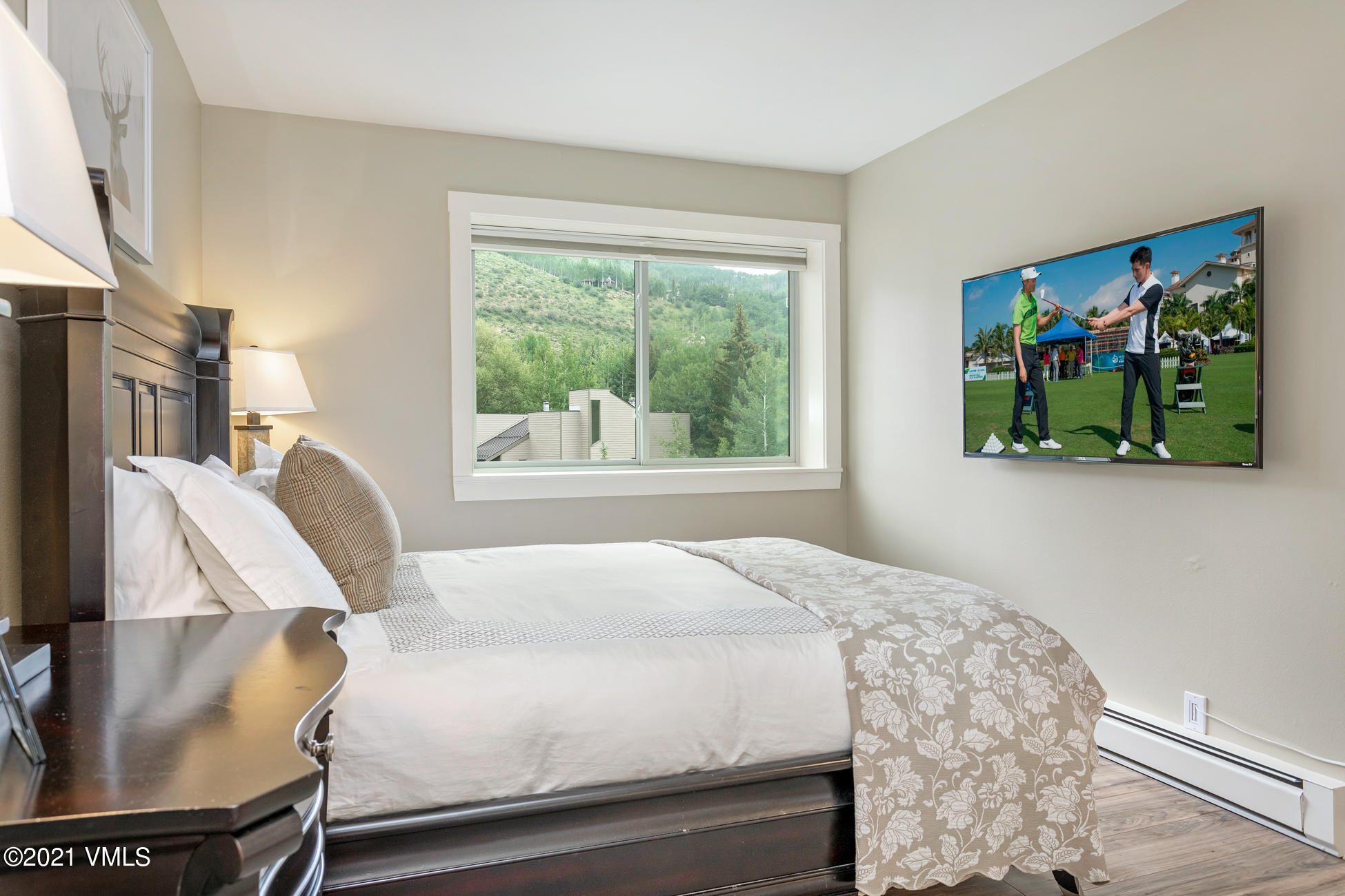 980 Vail View Drive, Unit 211B Vail, CO 81657 - Photo 14 of 21 a bedroom with a bed and a painting on the wall