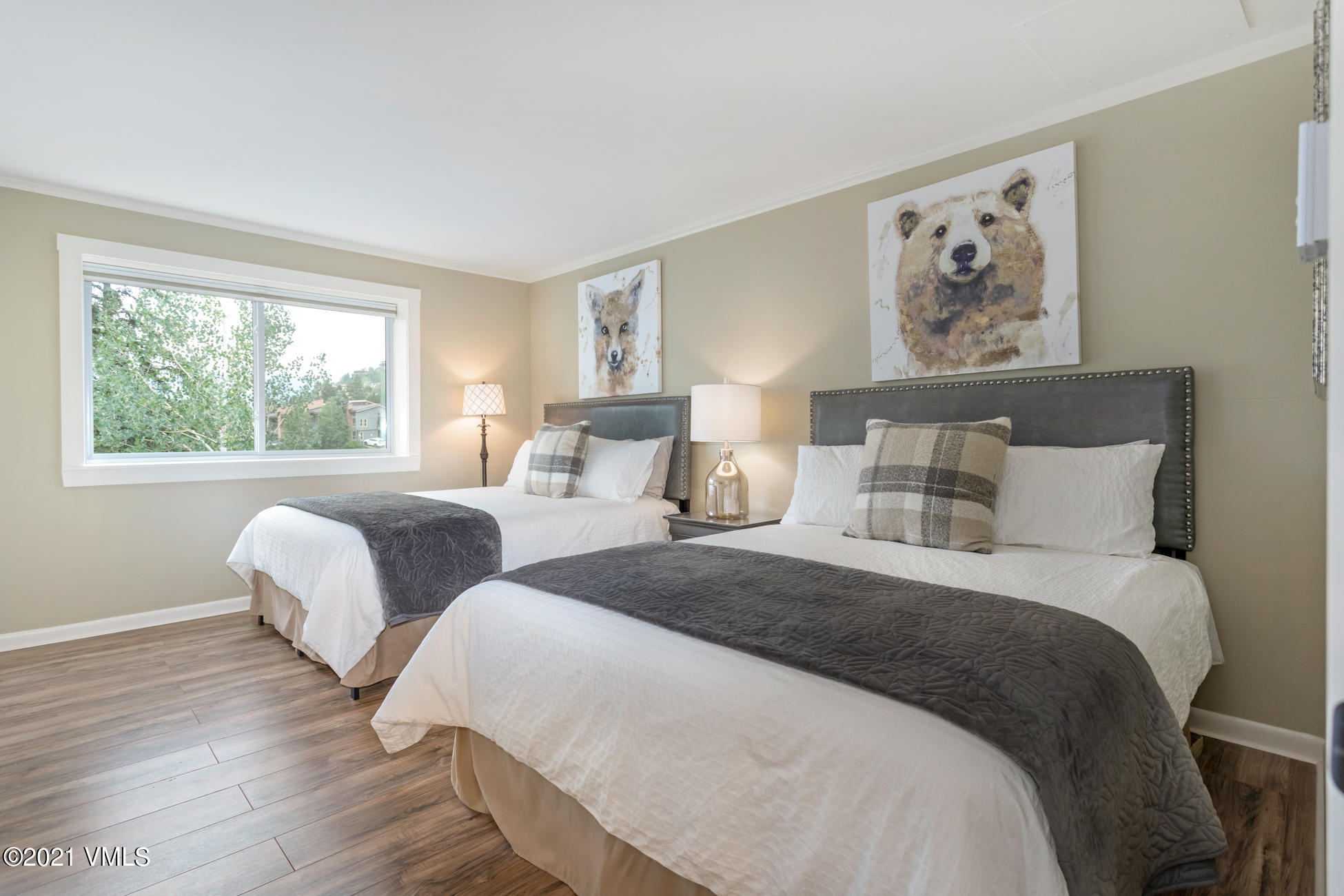 980 Vail View Drive, Unit 211B Vail, CO 81657 - Photo 16 of 21 a bedroom with two beds and a painting on the wall