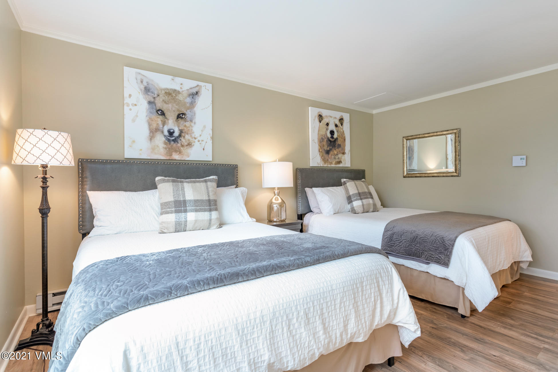 980 Vail View Drive, Unit 211B Vail, CO 81657 - Photo 17 of 21 a bedroom with two beds and painting on the wall