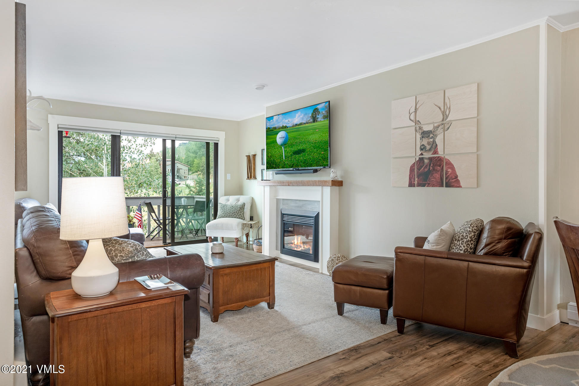980 Vail View Drive, Unit 211B Vail, CO 81657 - Photo 2 of 21 a living room with furniture a fireplace and a flat screen tv