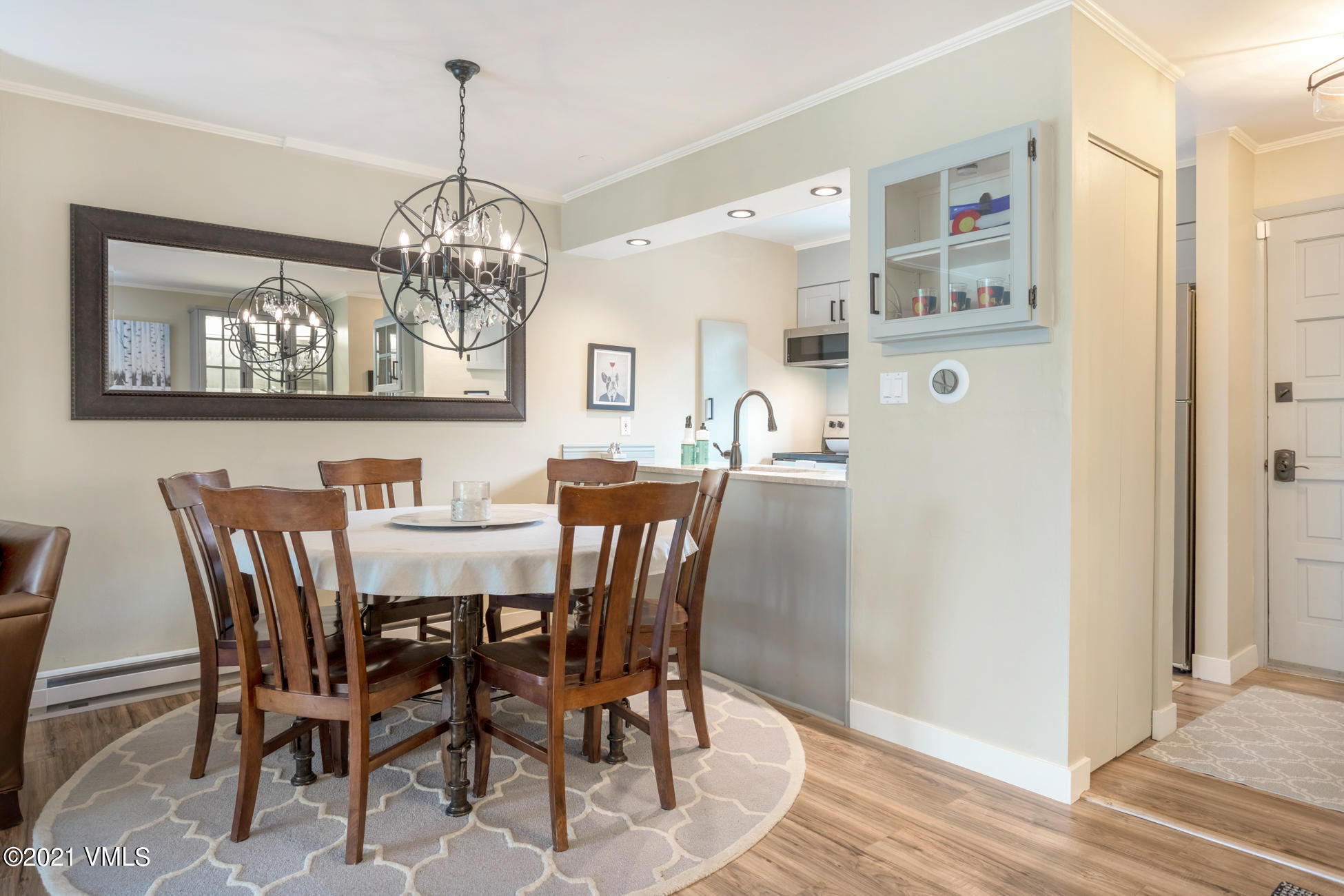 980 Vail View Drive, Unit 211B Vail, CO 81657 - Photo 4 of 21 a view of a dining room with furniture a chandelier and wooden floor