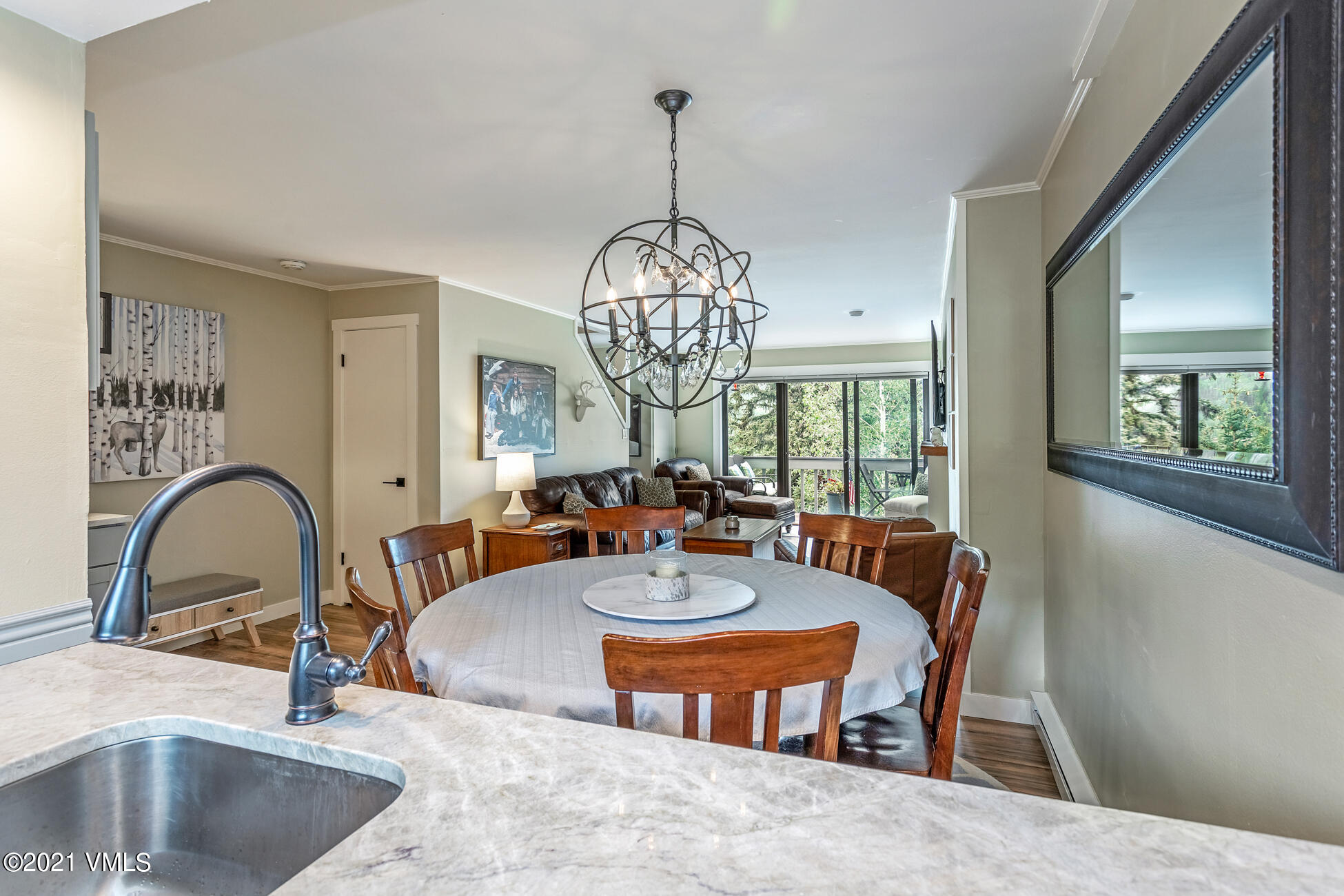 980 Vail View Drive, Unit 211B Vail, CO 81657 - Photo 5 of 21 a dining room with furniture a chandelier and window