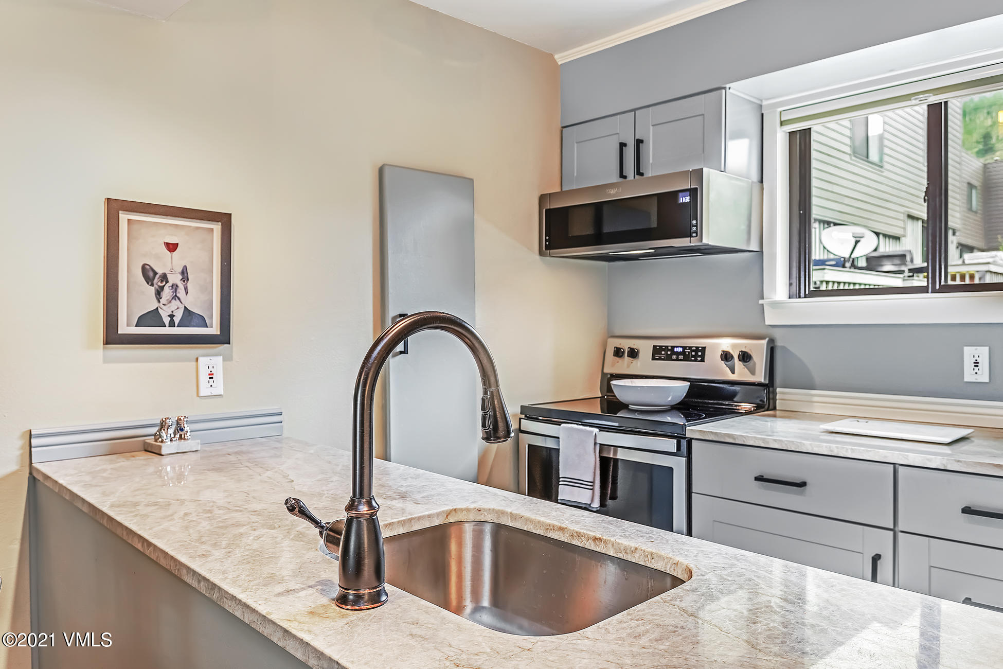 980 Vail View Drive, Unit 211B Vail, CO 81657 - Photo 7 of 21 a kitchen with stainless steel appliances granite countertop a sink stove top oven and microwave