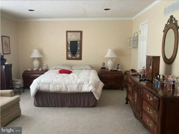 710 Fox Court Langhorne, PA 19047 - Photo 14 of 22 a bedroom with a bed a mirror and dresser