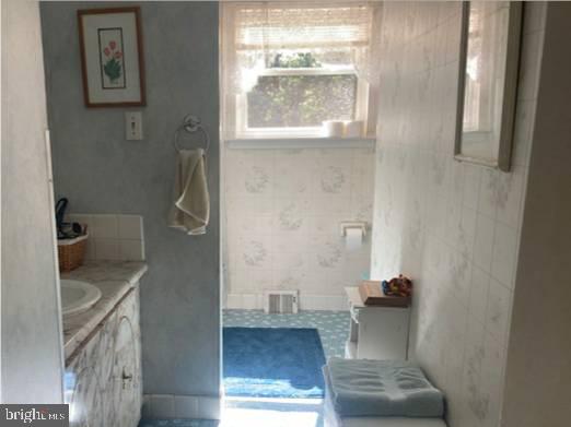 710 Fox Court Langhorne, PA 19047 - Photo 17 of 22 a bathroom with a sink and a mirror