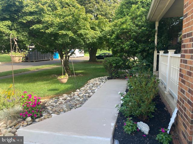 710 Fox Court Langhorne, PA 19047 - Photo 21 of 22 a view of a garden with a fountain and a bench