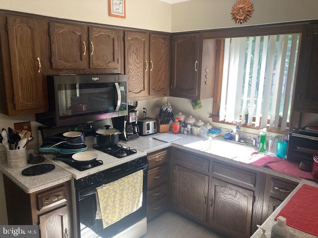 710 Fox Court Langhorne, PA 19047 - Photo 5 of 22 a kitchen with a sink stove and microwave