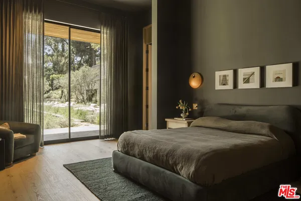 a bedroom with a large bed and a large window