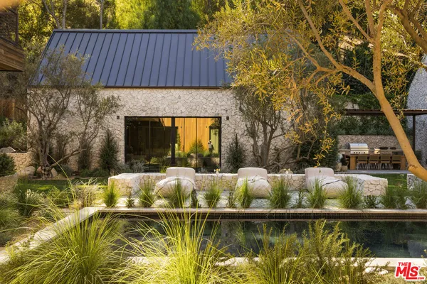 a view of house with outdoor space and swimming pool
