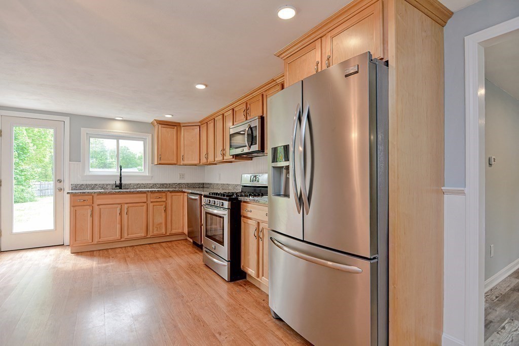 20 Alder Road Norton, MA 02766 - Photo 11 of 32 a kitchen with a refrigerator a sink and cabinets