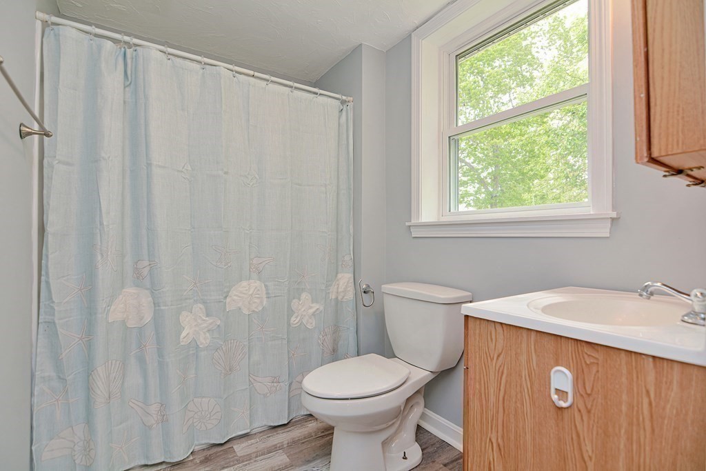 20 Alder Road Norton, MA 02766 - Photo 25 of 32 a bathroom with a sink a toilet and a window